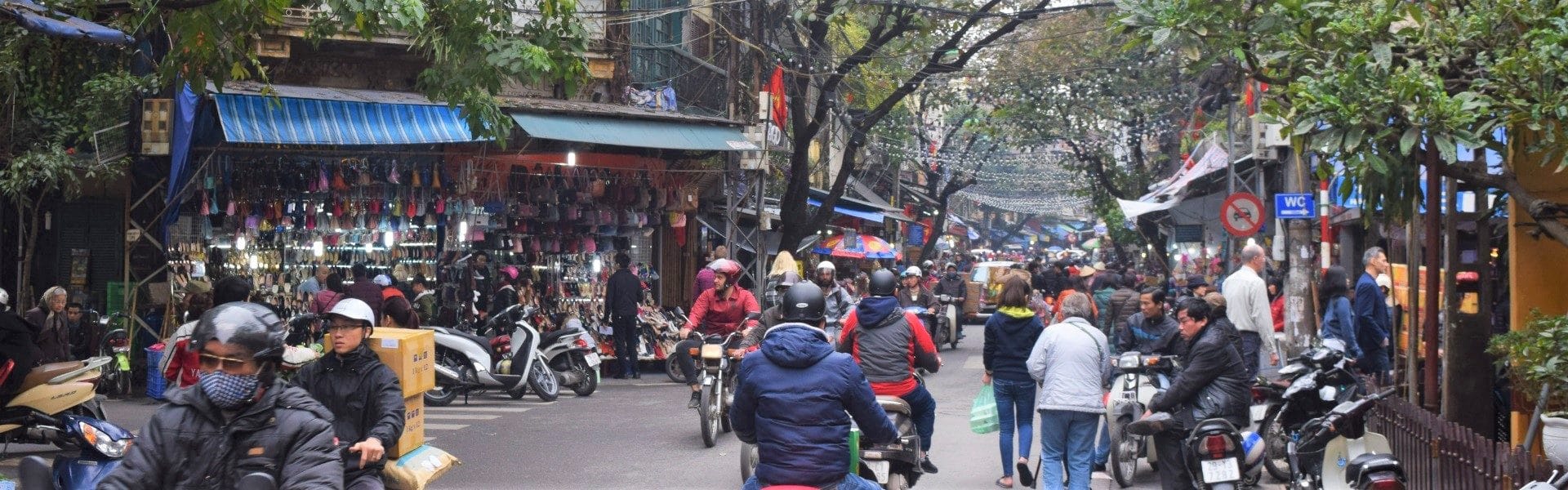 Busy street view with motorcycles and pedestrians - Things to do backpacking Vietnam on a Budget