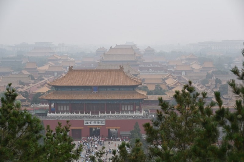 A view of the forbidden city from a hill covered in pollution