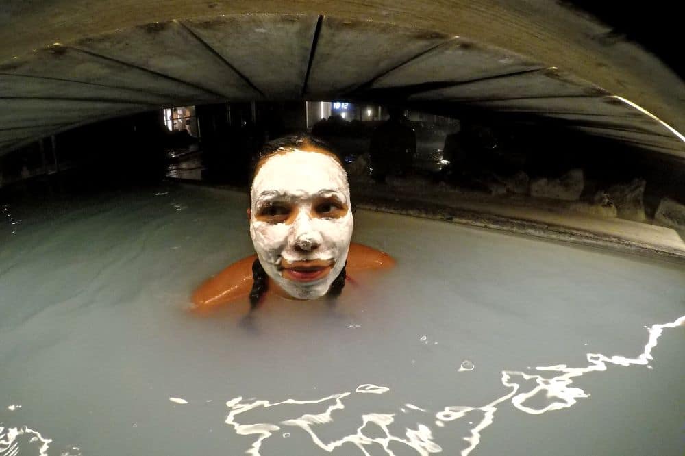 Girl wearing silica mask in Blue Lagoon in Iceland in November