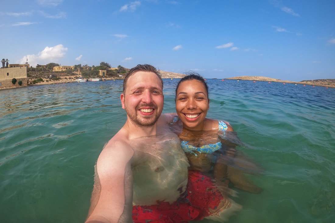 Couple taking selfie in the ocean