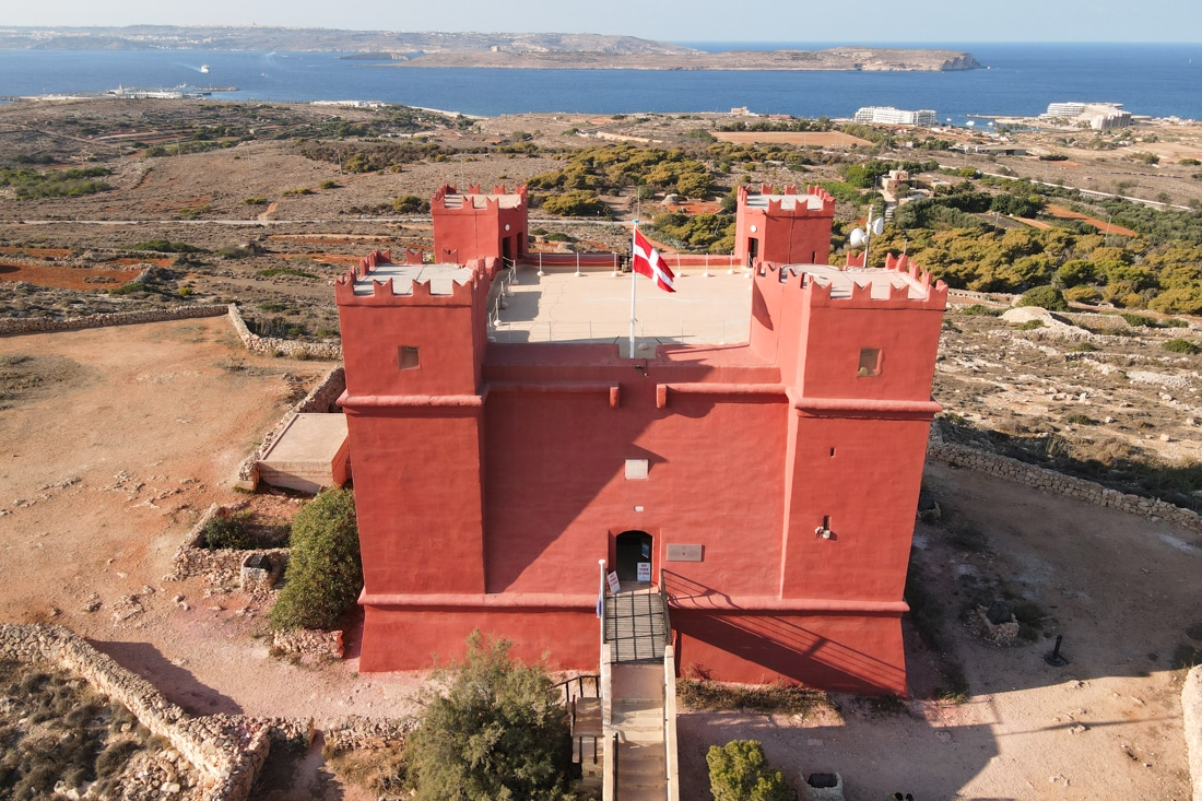 Red watchtower from above with four turrets