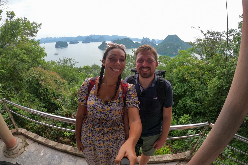 Two people taking a selfie with Halong Bay in the background