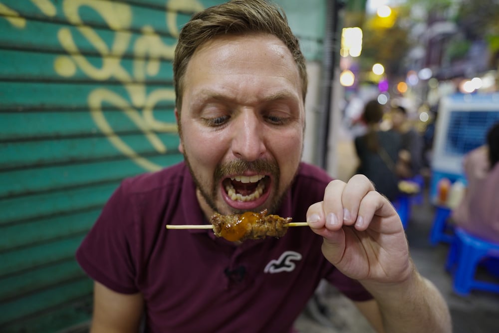 Kev eating spicy food on a Hanoi Street Food Tour